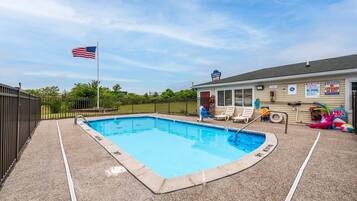 Enjoy a safe swim in our pool surrounded by lounge chairs and a children's play area.