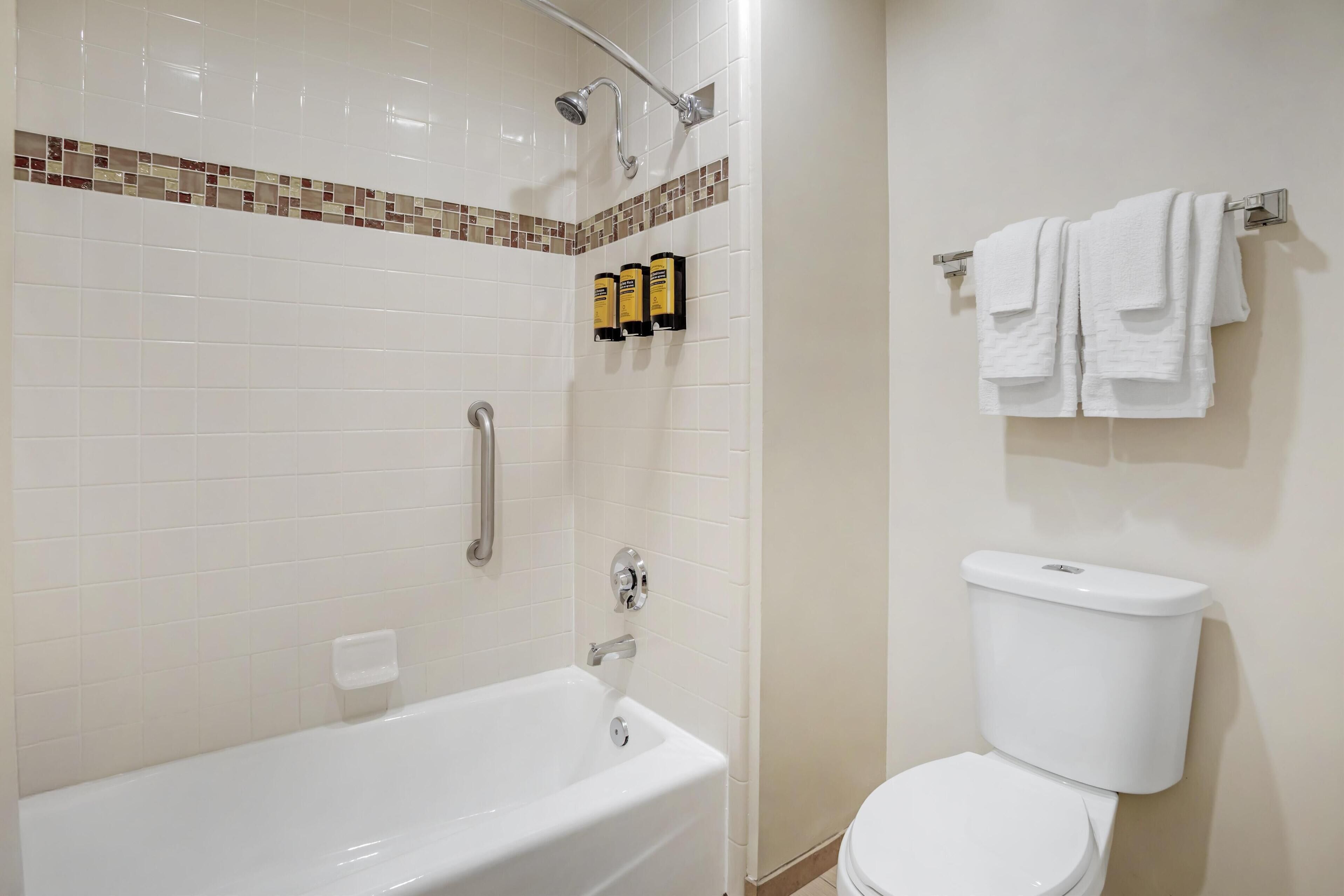 standard room, 1 king bed, non smoking, refrigerator & microwave (exterior corridor) | bathroom | combined shower/bathtub, designer toiletries, hair dryer, towels