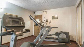 A gym with treadmills, an elliptical, and a stationary bike.