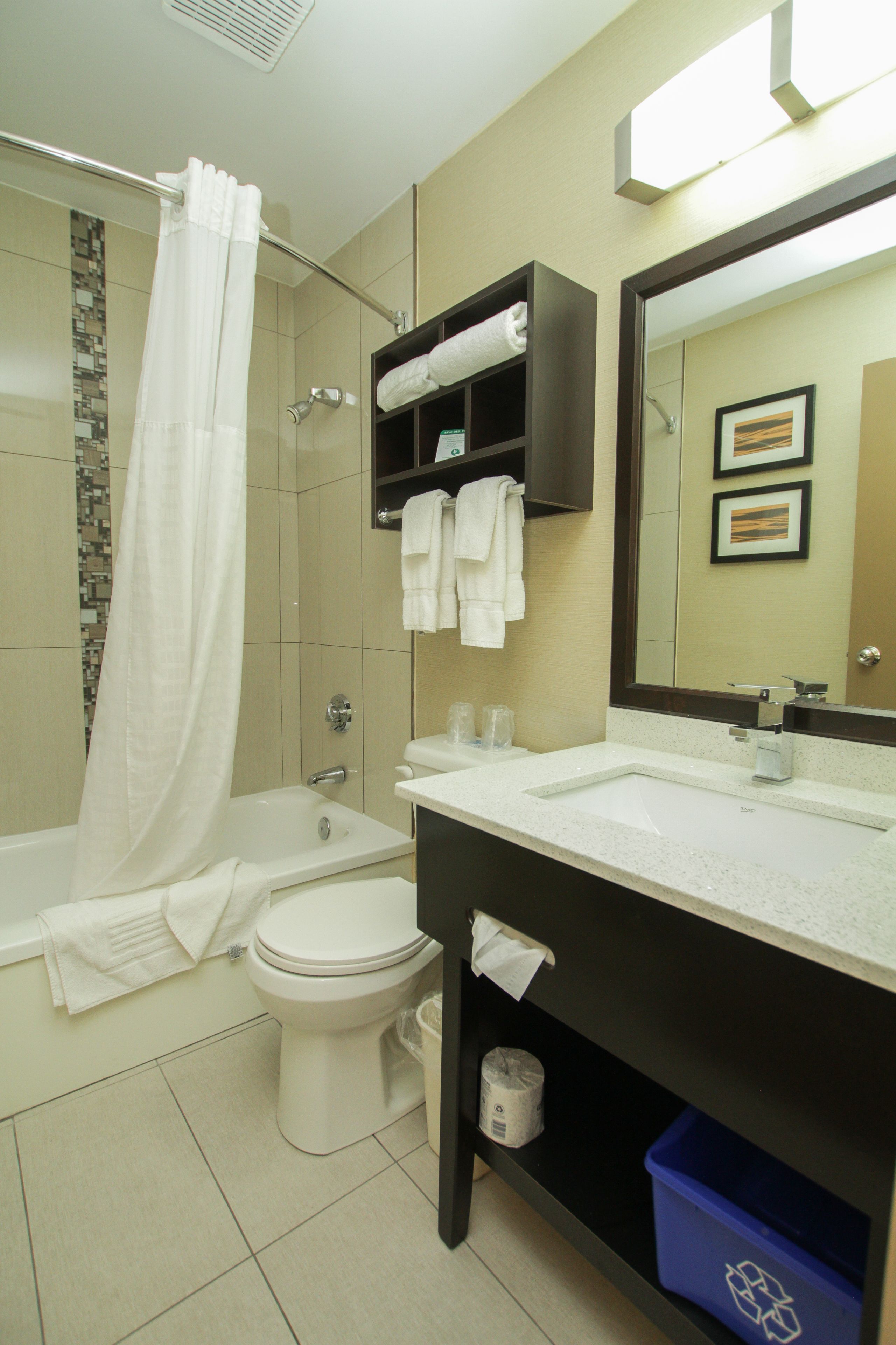A bathroom with a bathtub, toilet, sink, and a shower curtain.