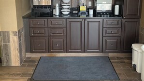 A modern kitchen with a coffee station, including a coffee machine and a water dispenser. - Comfort Inn (Cornwall)