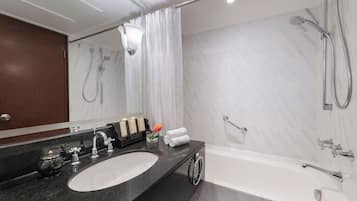 A modern bathroom with a large sink, a bathtub, and a shower.