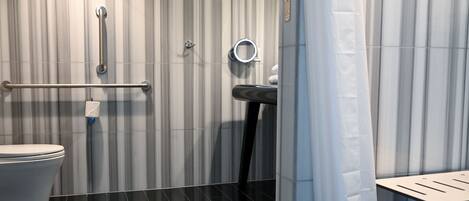 A modern bathroom with a toilet, a sink, and a shower area.