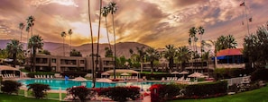 A resort with a swimming pool, palm trees, and a mountain backdrop. - Shadow Mountain Resort (Palm Desert)