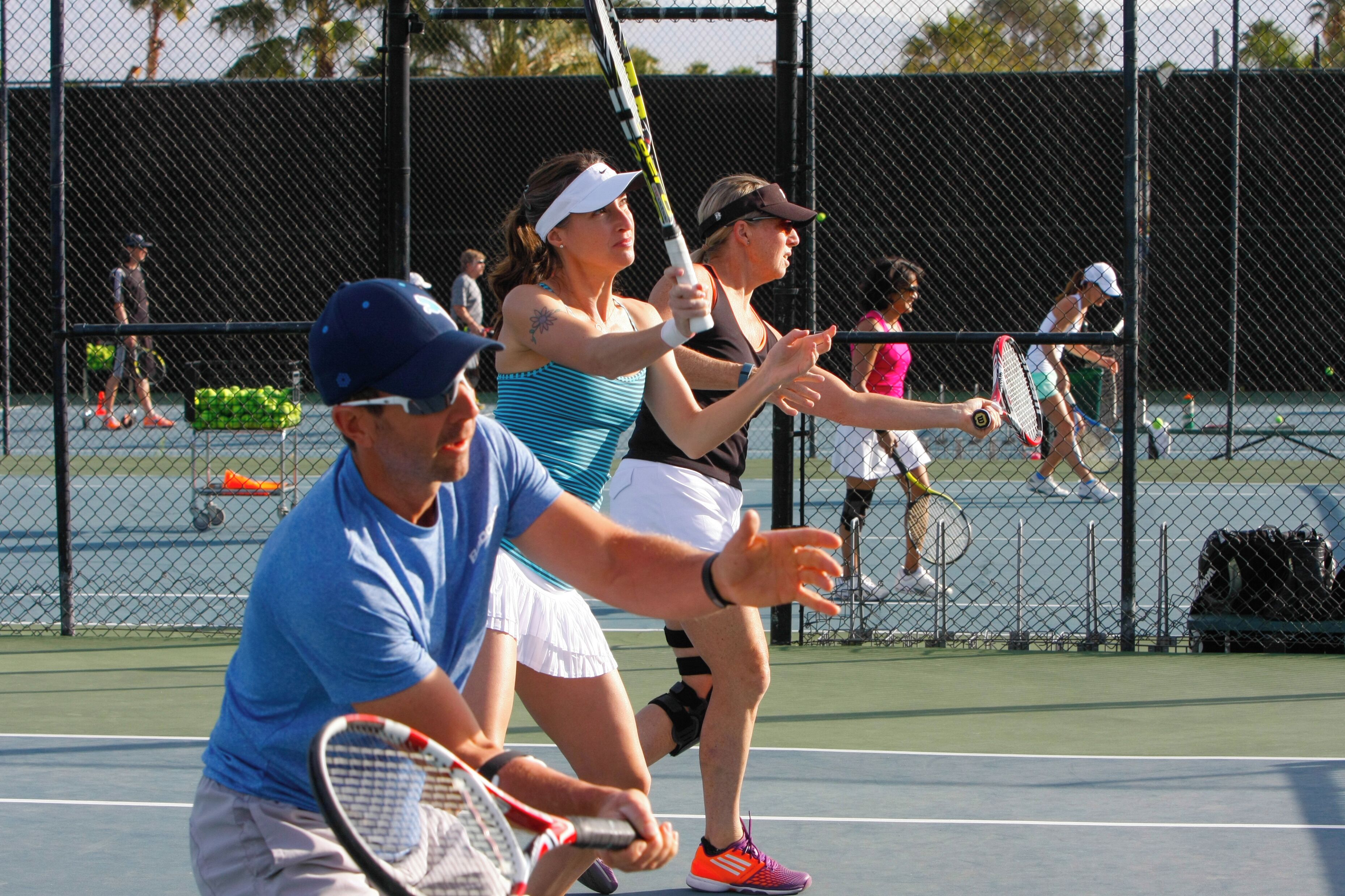 A tennis court with players in action.