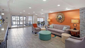 A spacious lobby with a large seating area, a reception desk, and a view of the dining area through glass doors. - Best Western Plus Chicagoland - Countryside (Countryside)