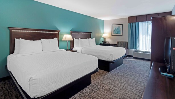 A hotel room with two beds, a desk with a television, a chair, and a window with curtains. - Best Western Plus Chicagoland - Countryside (Countryside)