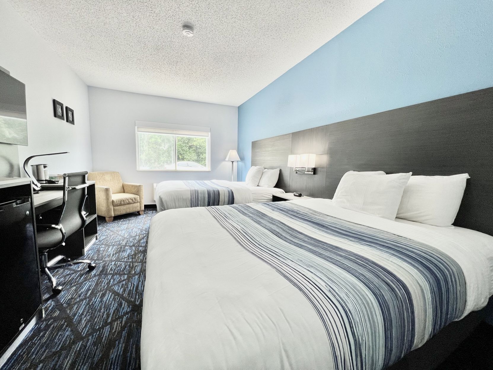 Premium bedding, pillow-top beds, desk, laptop workspace