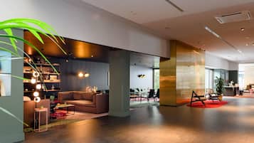 A modern interior with a sofa, a coffee table, and a bookshelf.