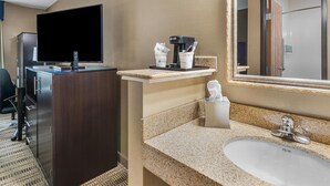 A hotel room with a flat-screen TV, a coffee maker, a sink, and a mirror. - Best Western Providence Warwick Airport Inn (Warwick)