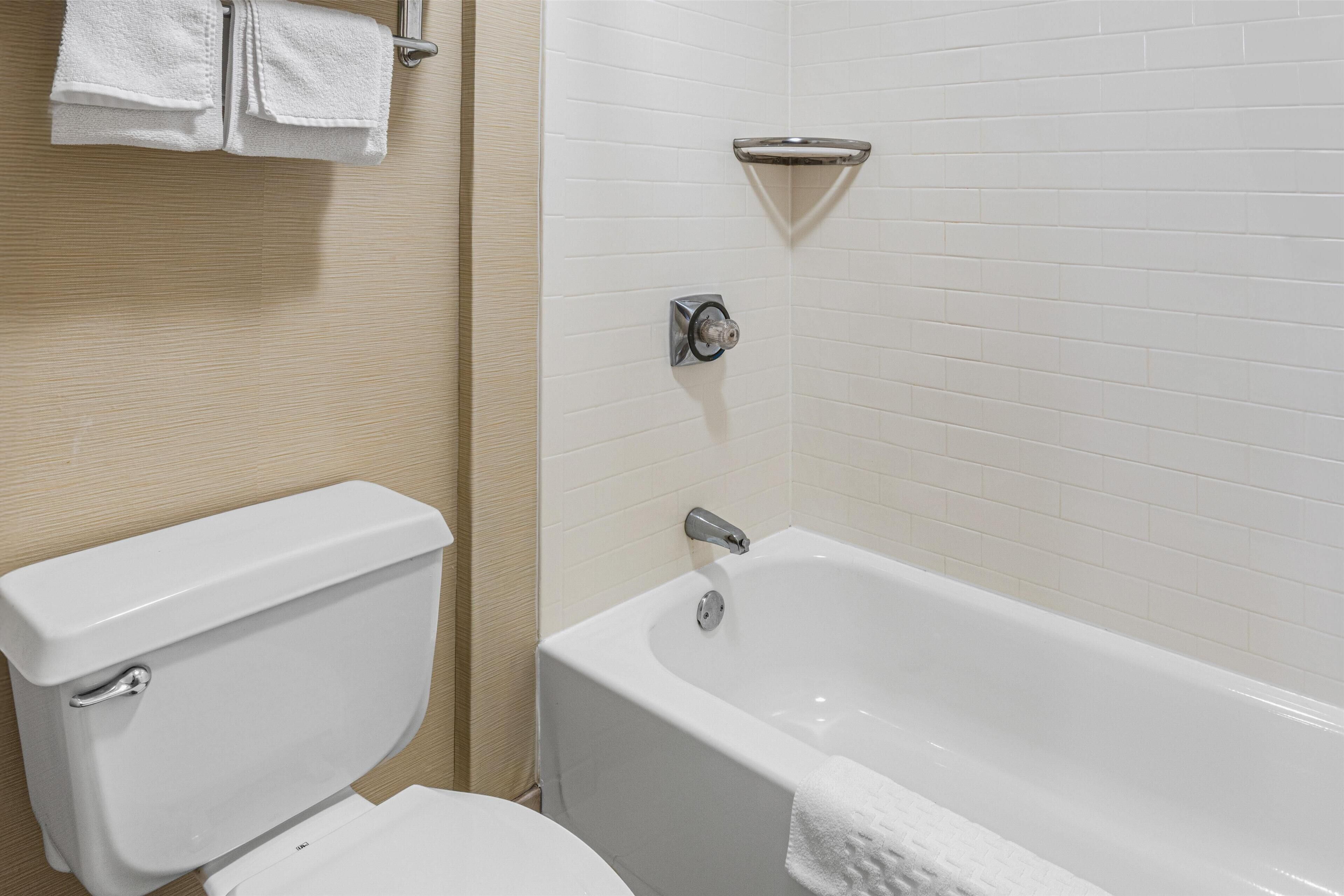 standard room, 2 queen beds, non smoking, refrigerator & microwave | bathroom | combined shower/bathtub, free toiletries, hair dryer, towels