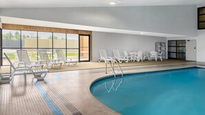 A swimming pool with lounge chairs and a sun terrace.