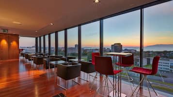 Enjoy a panoramic city view from the comfort of this spacious room with a large seating area and unobstructed views of the city and distant mountains.