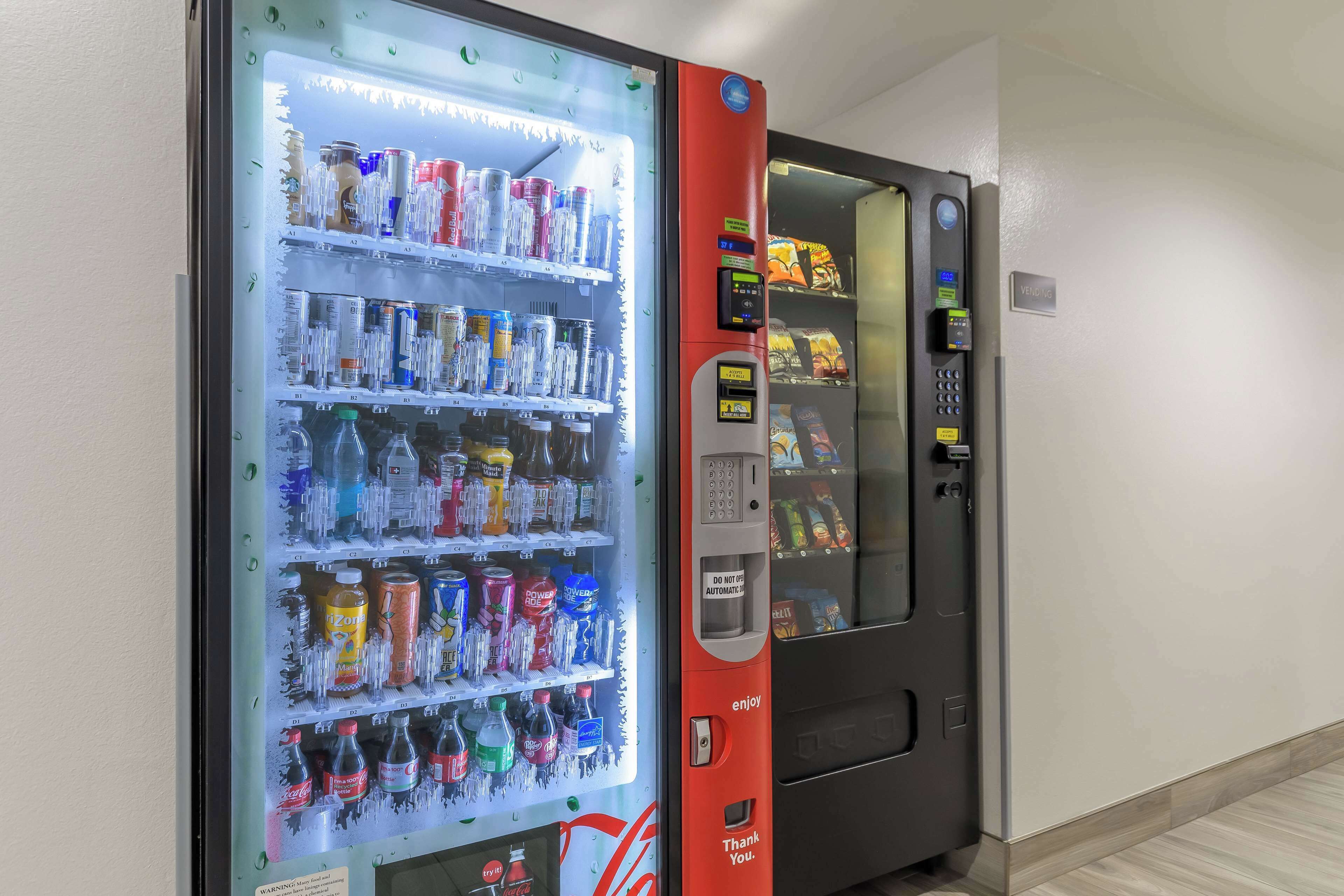 A vending machine with a variety of beverages and snacks, including Coca-Cola and Doritos.