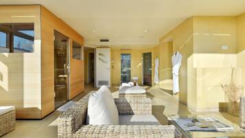 Relax in a comfortable seating area with wicker sofas and a glass-top coffee table.