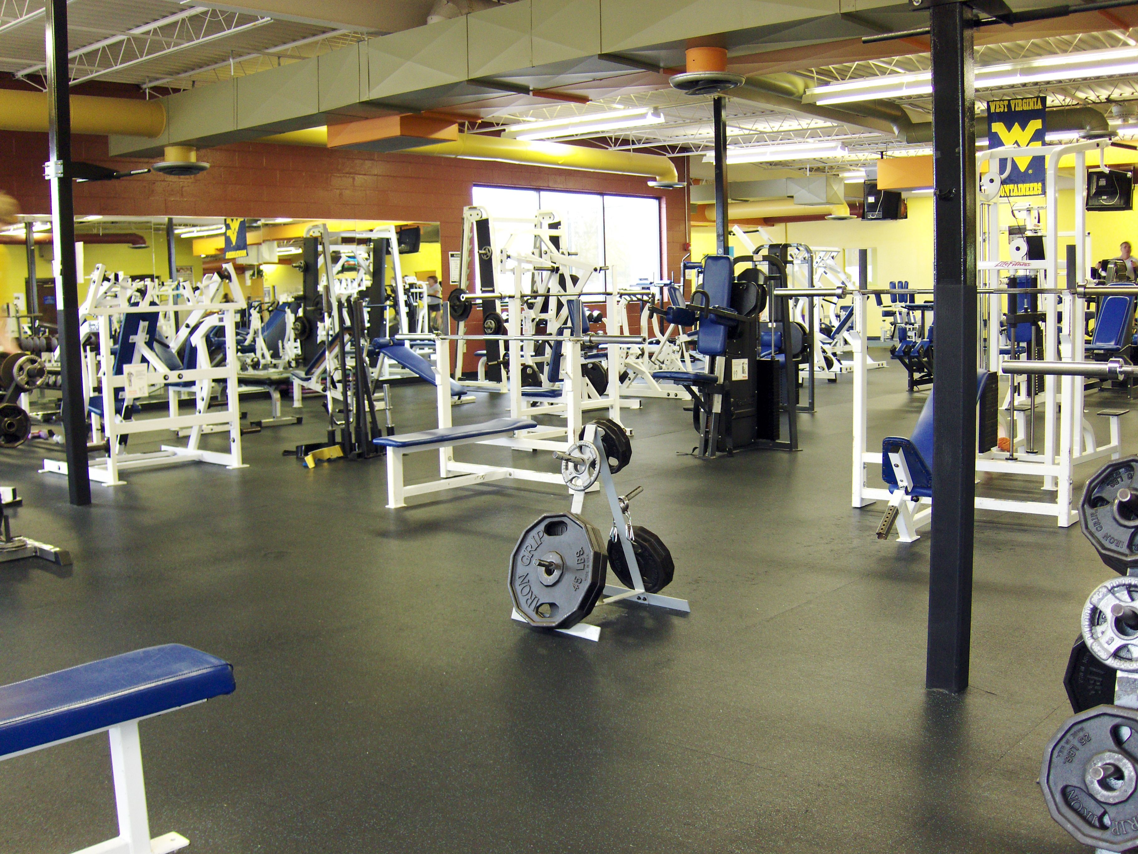 A gym with various exercise equipment, including weight machines and free weights.