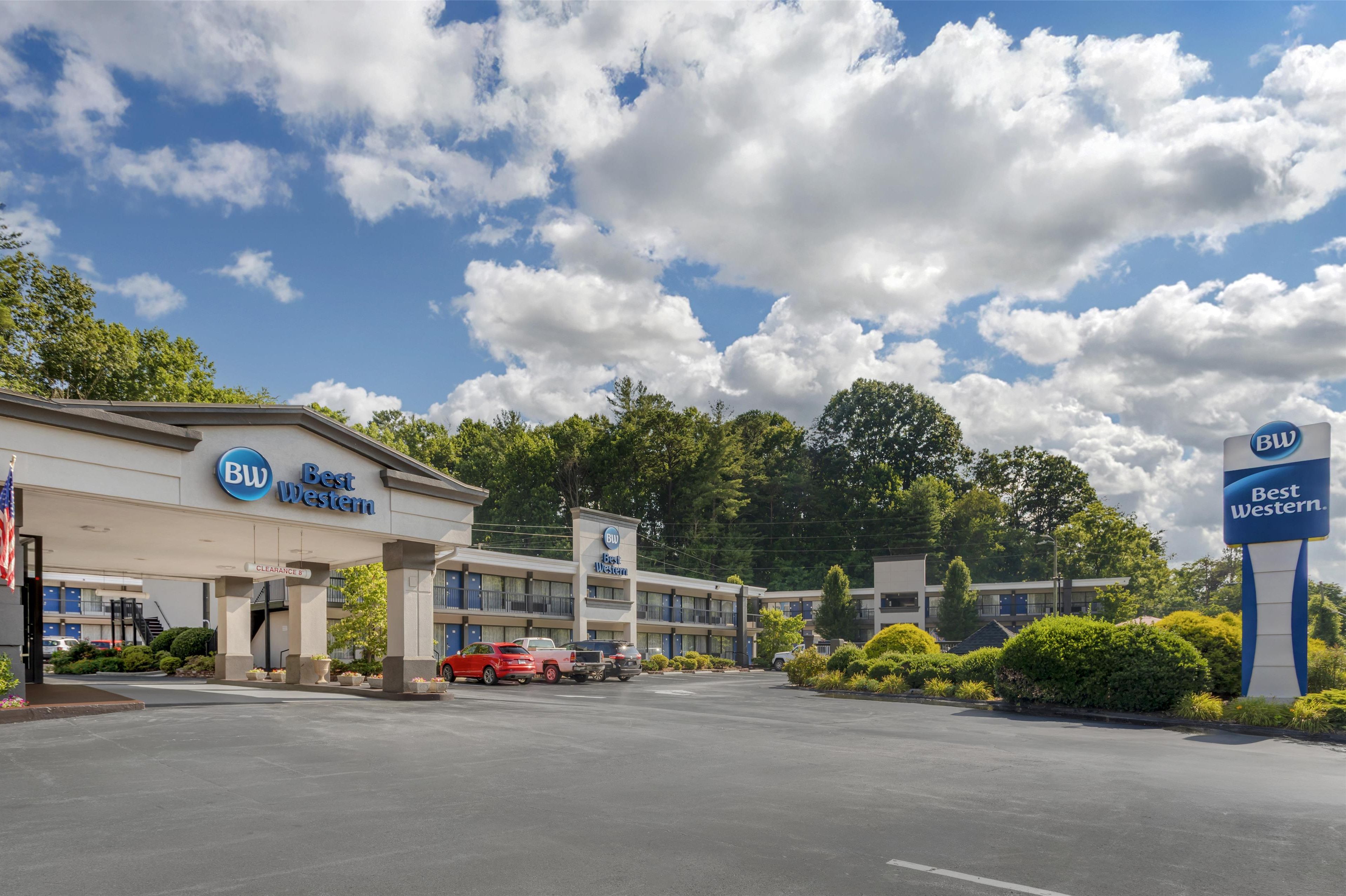 A Best Western hotel with a clear sky and clouds, multiple parking spaces, and a well-maintained exterior.