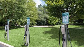 Una estación de carga con un letrero que indica que es solo para coches eléctricos durante la carga.