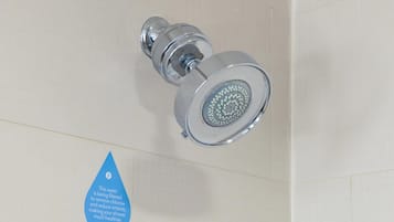 A showerhead with a water filtration sign.