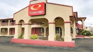 A two-story EconoLodge building with a beige facade and red accents. - Econo Lodge San Marcos University Area (San Marcos)