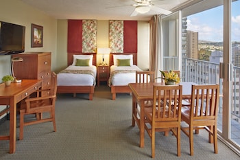 In-room safe, desk, laptop workspace, blackout drapes at Pacific Monarch Hotel
