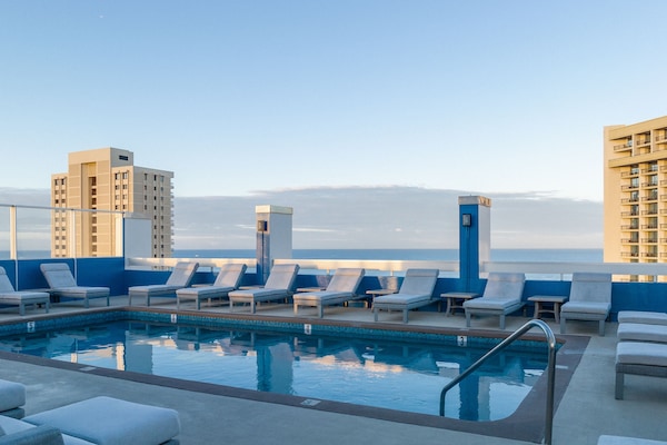 Outdoor pool, open 6:00 AM to 10:00 PM, sun loungers