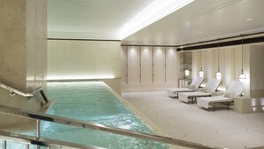 A spa area with a pool, lounge chairs, and a reception desk. - The Lanesborough, Oetker Hotels (London)