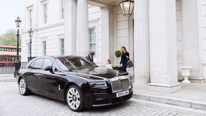 A black luxury car parked in front of a classical building with columns and a lamp post. - The Lanesborough, Oetker Hotels (London)