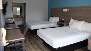 A hotel room with two beds, a desk, a chair, a television, and a window. - Americas Best Value Inn & Suites Murfreesboro (Murfreesboro)