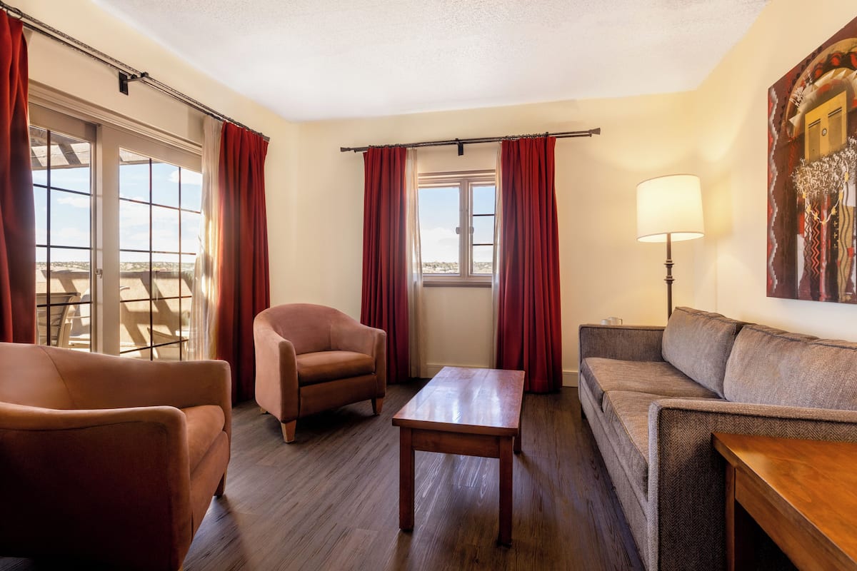 Una sala de estar con un sofá, un sillón y una mesa.