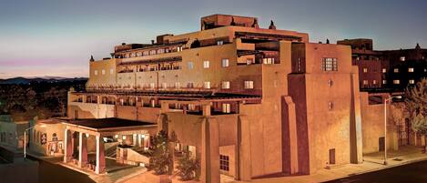 A large, multi-story building with a prominent entrance and a courtyard.