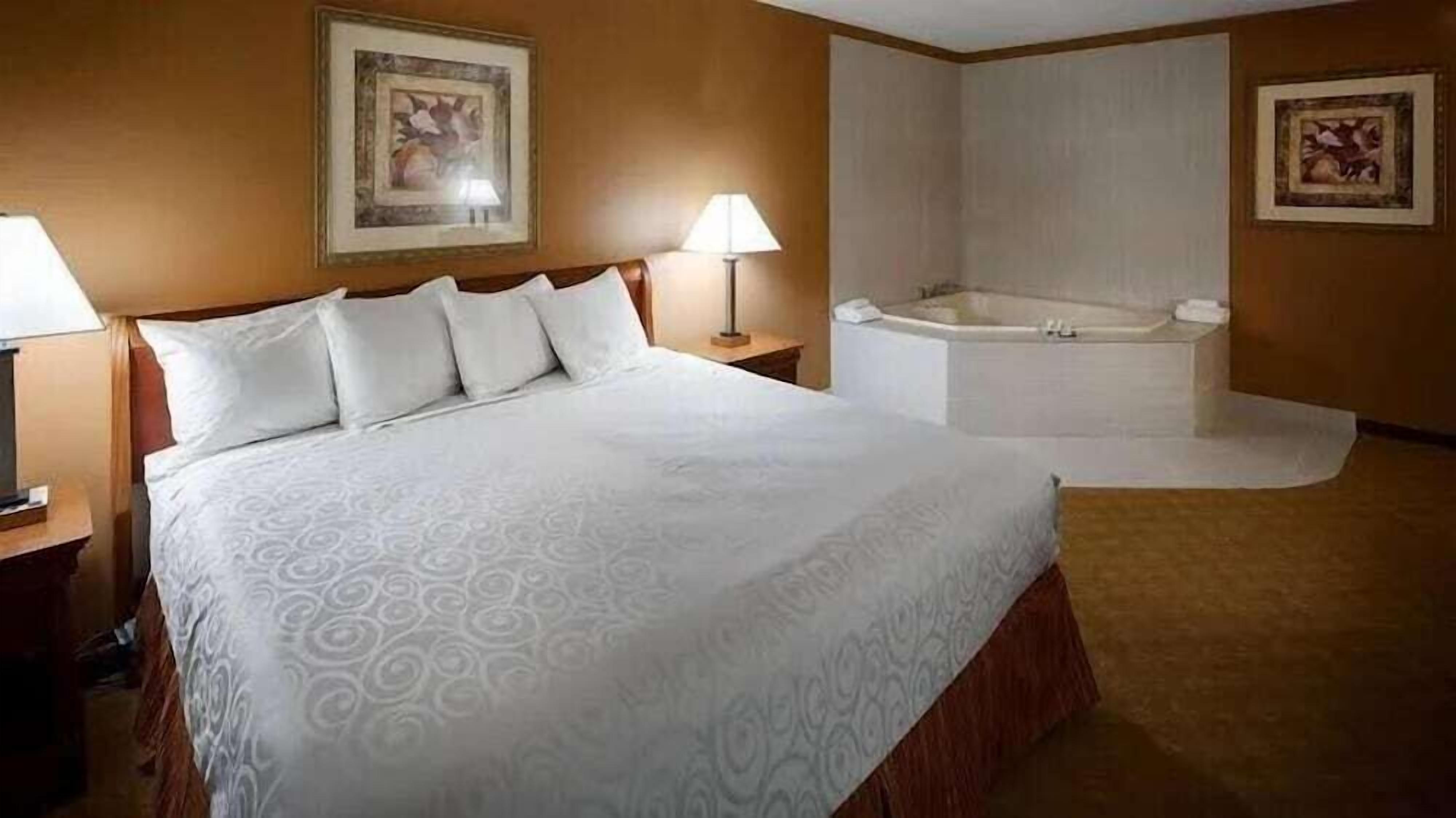 Desk, laptop workspace, iron/ironing board, bed sheets