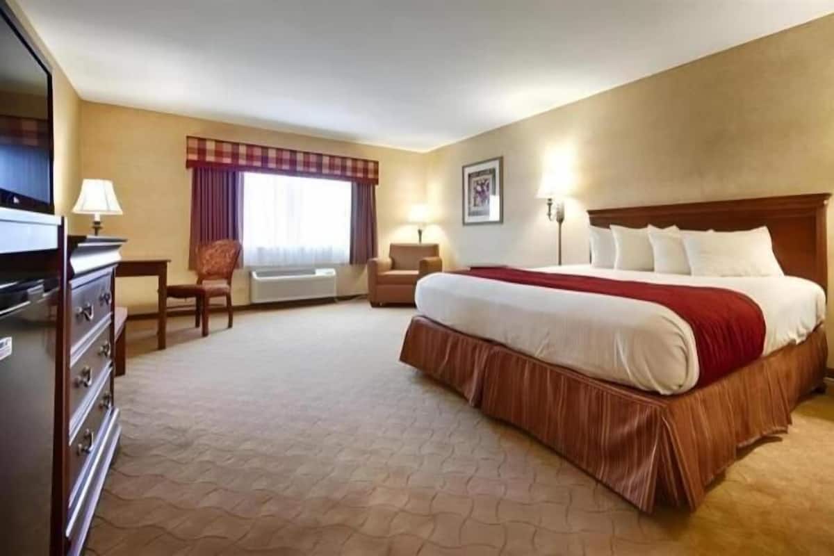 Desk, laptop workspace, iron/ironing board, bed sheets