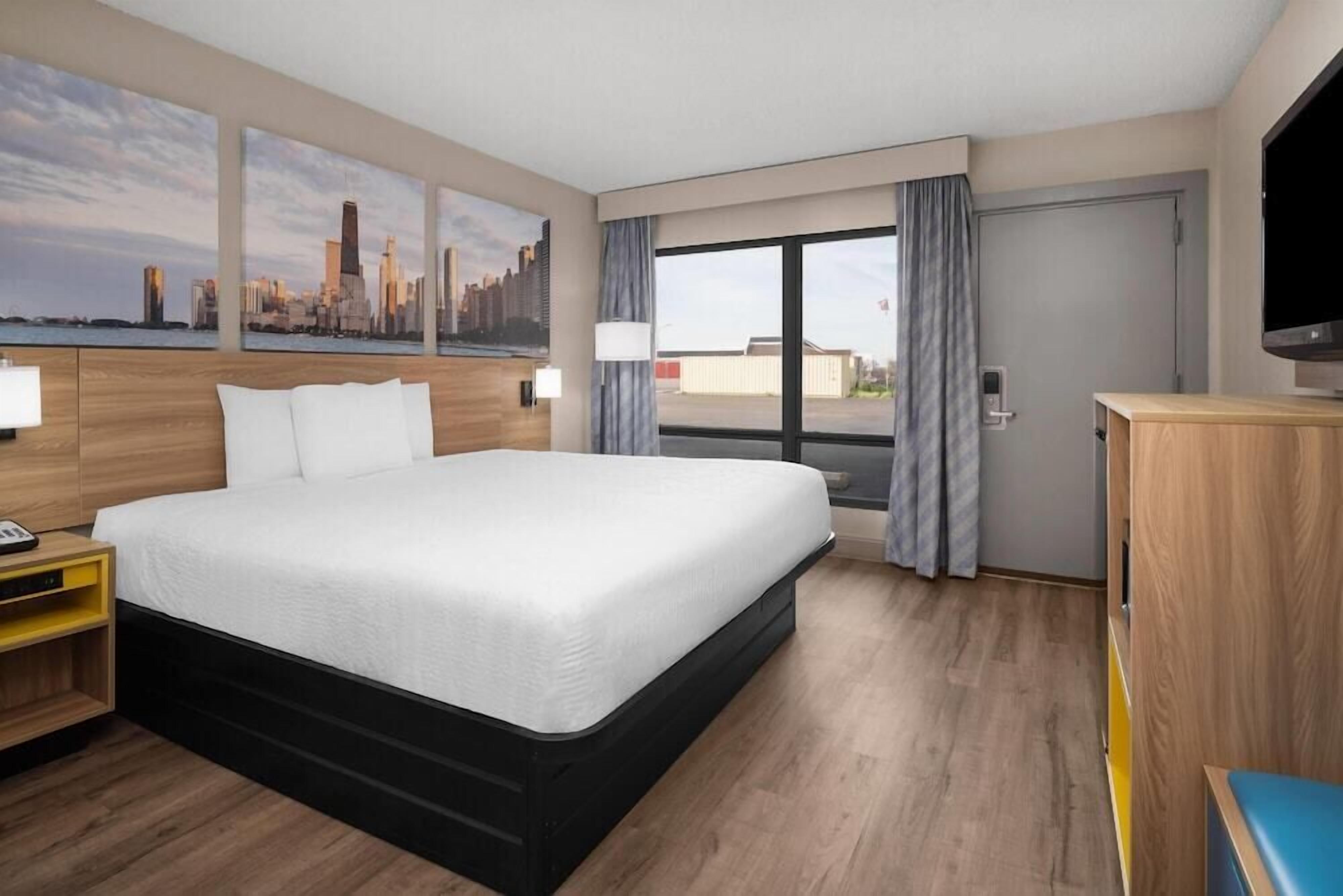Desk, laptop workspace, iron/ironing board, bed sheets