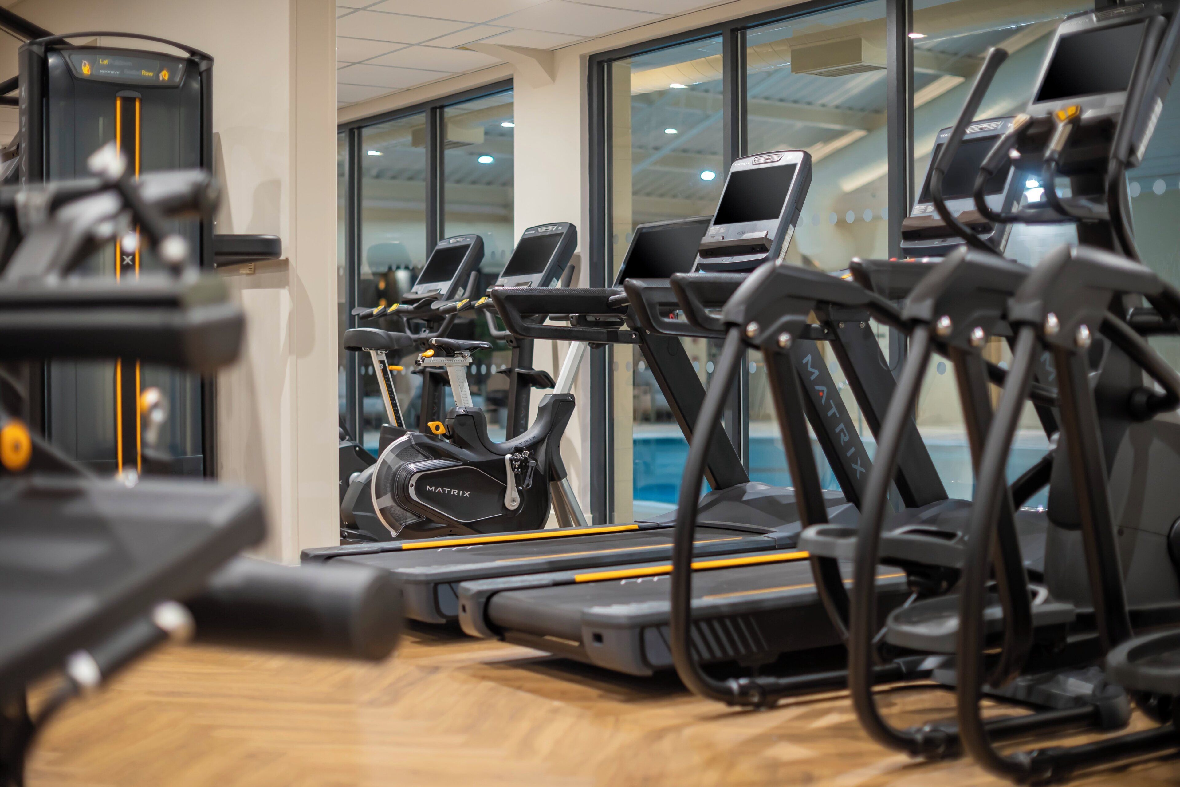 A gym with multiple treadmills and exercise equipment.