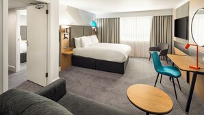 A hotel room with a bed, a desk, a chair, a sofa, and a TV. - Holiday Inn Southampton-Eastleigh M3, jct13 by IHG (Eastleigh)