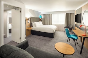 A hotel room with a bed, a desk, a chair, a sofa, and a TV. - Holiday Inn Southampton-Eastleigh M3, jct13 by IHG (Eastleigh)