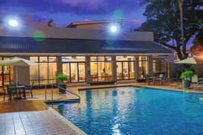 A hotel with a swimming pool, outdoor seating, and a restaurant. - Holiday Inn Harare by IHG (Harare)