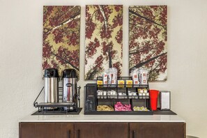 A coffee station with two coffee makers, a milk frother, and a variety of coffee pods and creamer packets. - Red Roof Inn Stroudsburg (Stroudsburg)