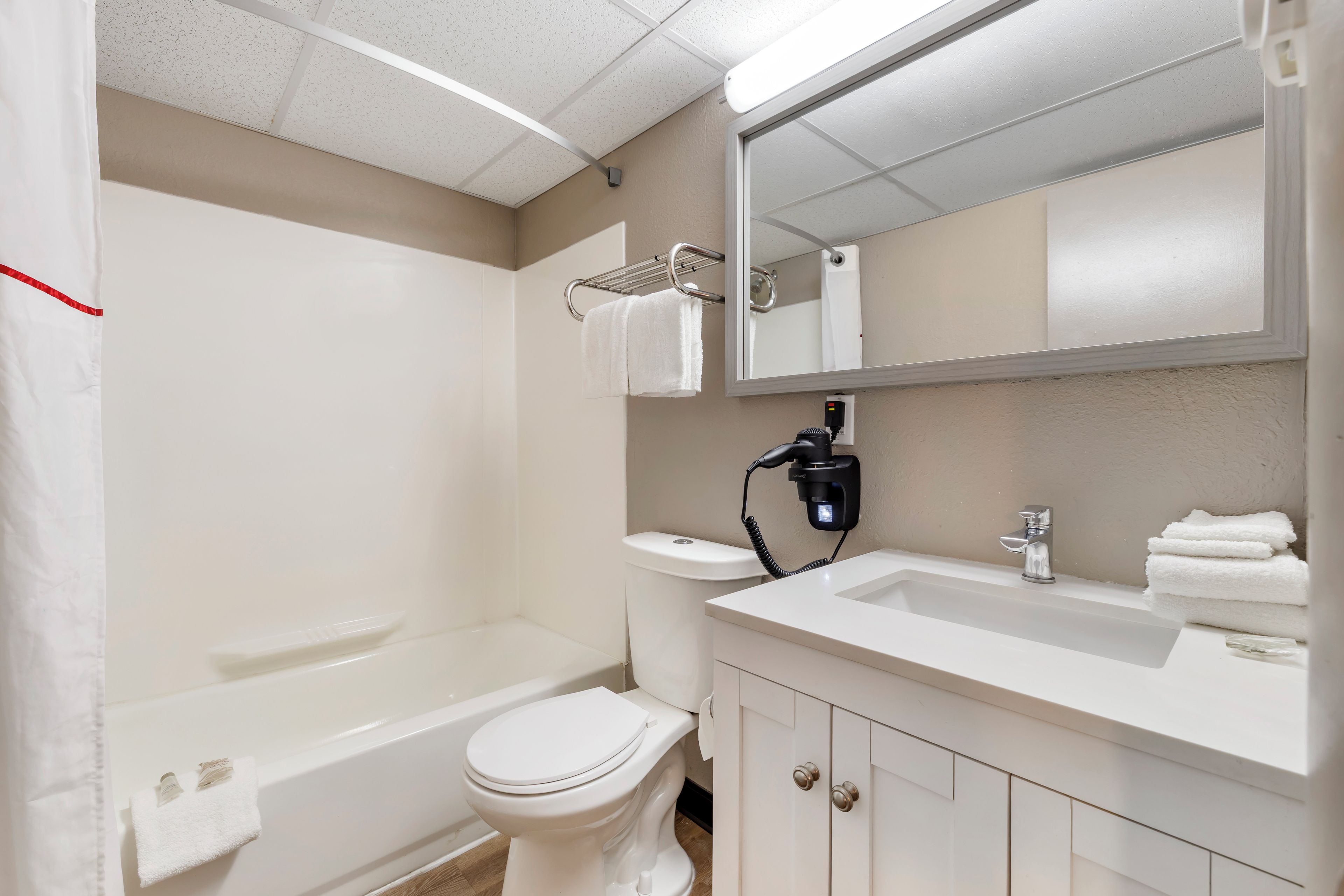 A bathroom with a toilet, sink, and bathtub.