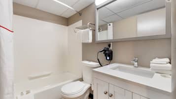 A bathroom with a toilet, sink, and bathtub.