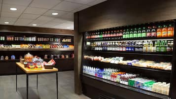 A well-lit grocery store with shelves stocked with snacks, beverages, and packaged goods.
