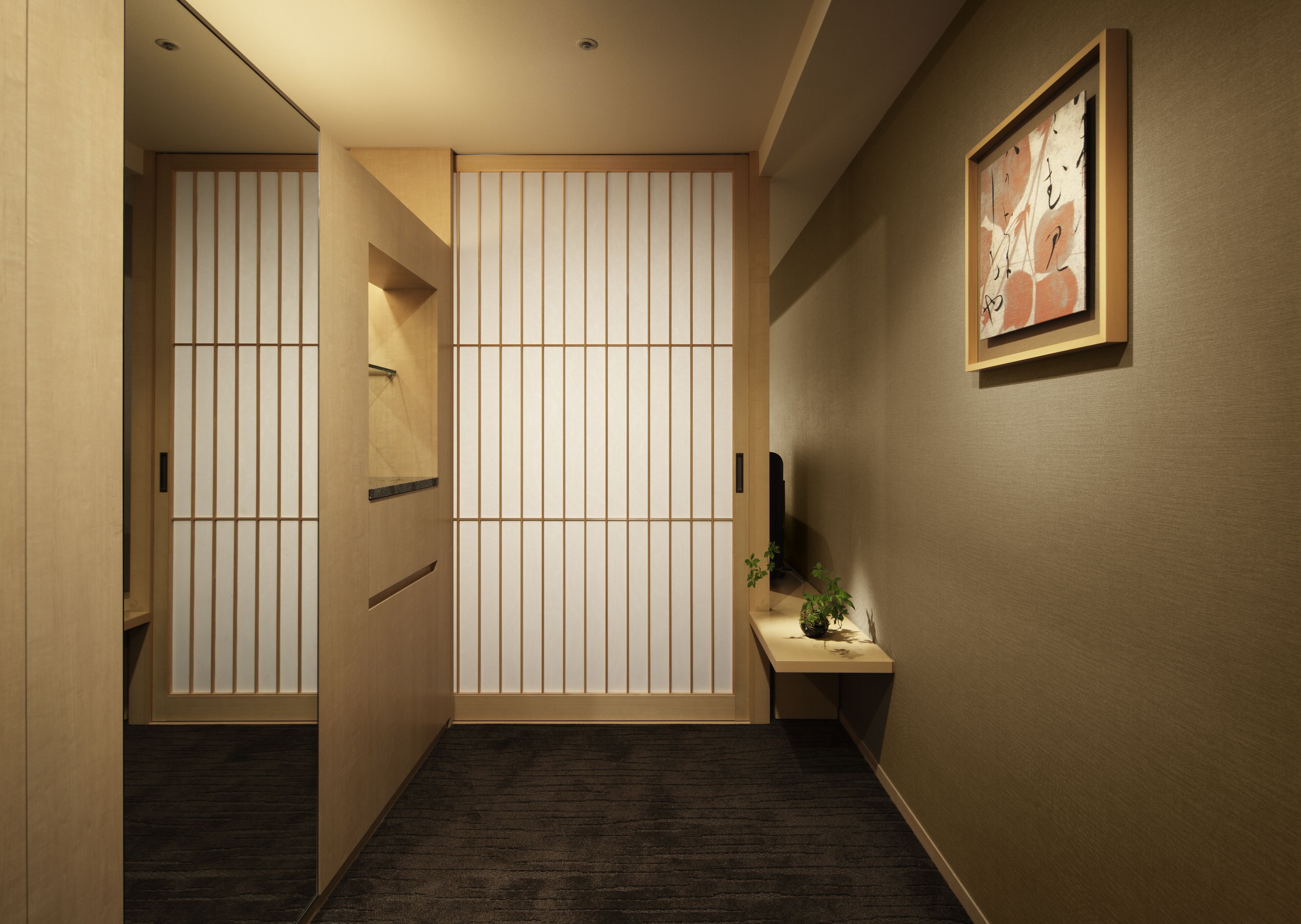 A hallway with a sliding door, a small table with a plant, and a framed artwork on the wall.