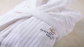 A white towel with a label that reads 'CAPITOL HOTEL TOKYO'.