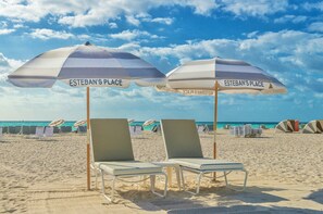 On the beach, white sand, beach towels, beach bar