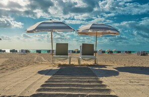 On the beach, white sand, beach towels, beach bar
