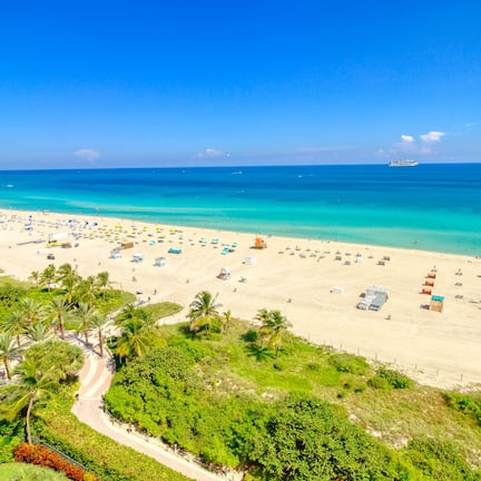 On the beach, white sand, beach cabanas, sun loungers