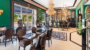 A spacious lobby with a chandelier, seating area, and a view of the outdoors.