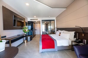 Relax in a serene space with a large bed, flat-screen TV, and desk area.