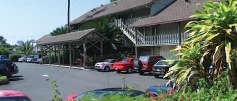 A two-story building with a covered outdoor area and a staircase leading to the upper floor.